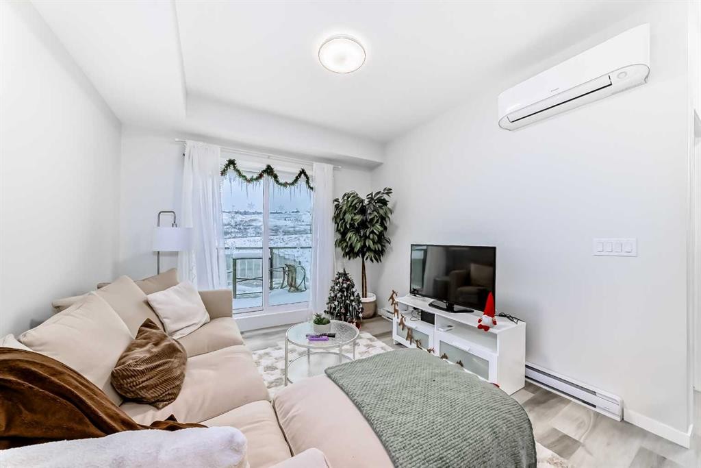 2401-42 Cranbrook Gardens Se, Calgary, AB - Indoor Photo Showing Living Room With Fireplace