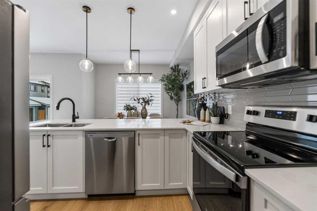 241 Waterford Heath, Chestermere, AB - Indoor Photo Showing Kitchen With Double Sink With Upgraded Kitchen