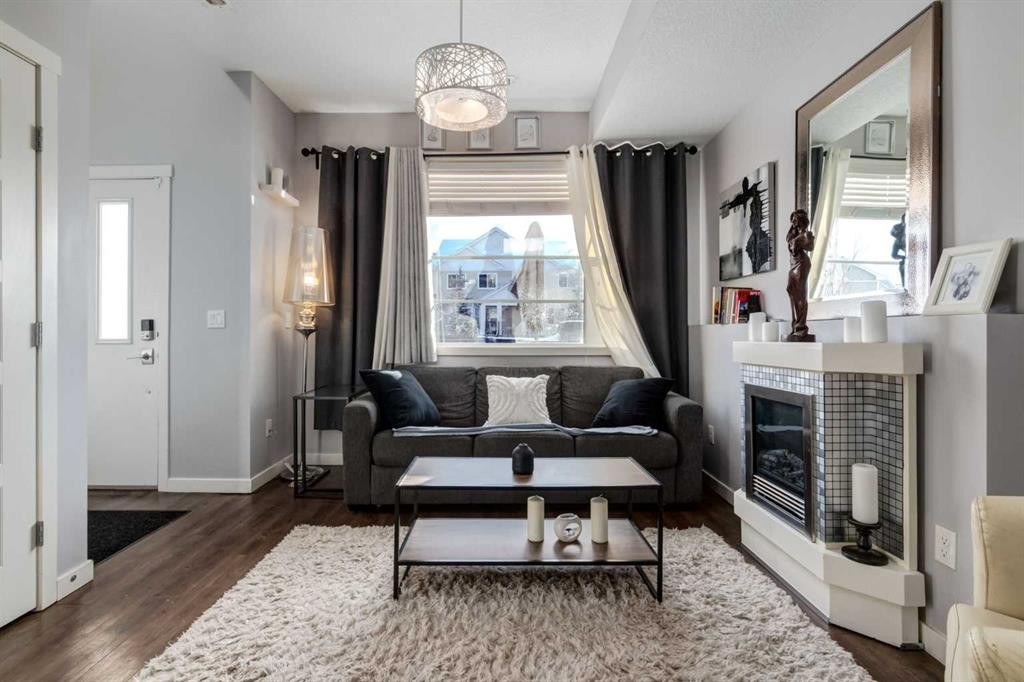 415 Saddlemont Boulevard Ne, Calgary, AB - Indoor Photo Showing Living Room With Fireplace
