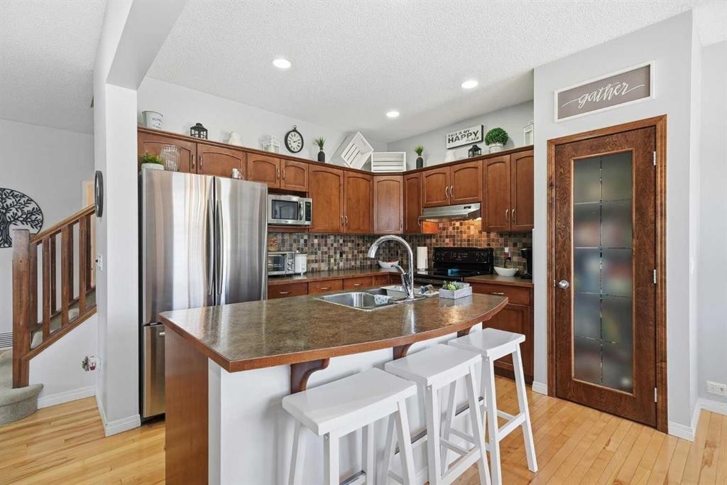 155 Cimarron Grove Circle, Okotoks, AB - Indoor Photo Showing Kitchen With Stainless Steel Kitchen With Double Sink