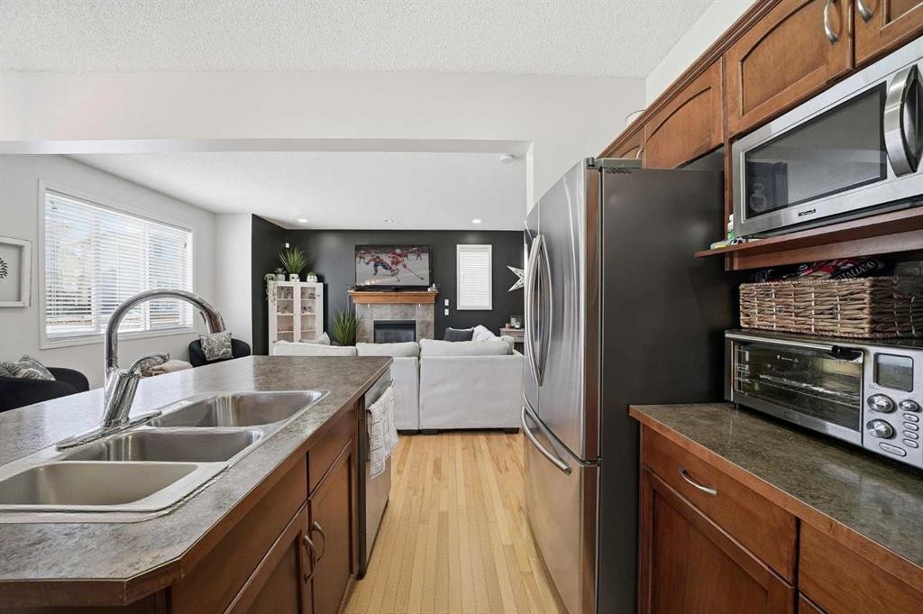 155 Cimarron Grove Circle, Okotoks, AB - Indoor Photo Showing Kitchen With Double Sink