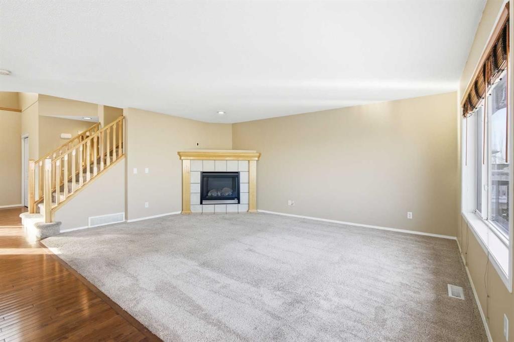 202 Panamount Court Nw, Calgary, AB - Indoor Photo Showing Living Room With Fireplace