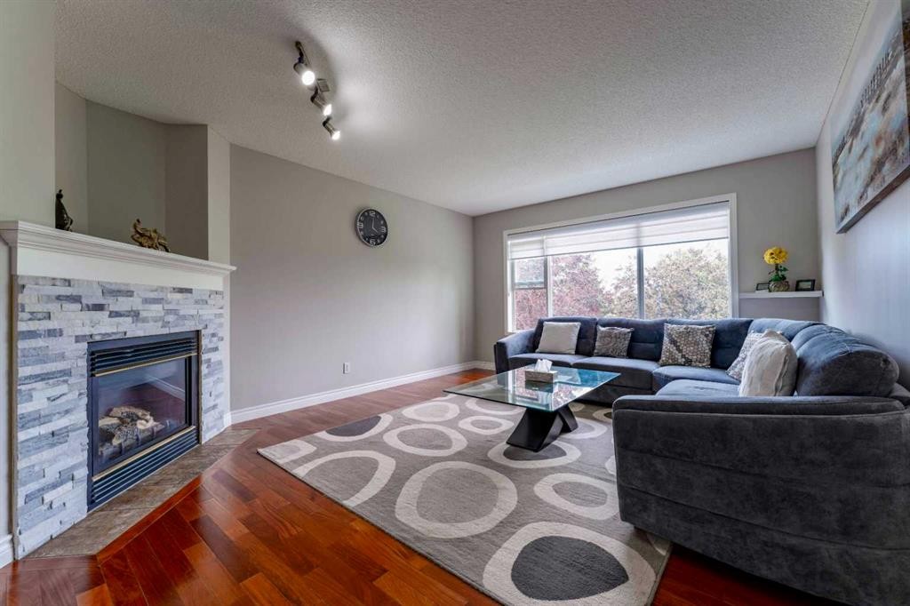 276 Fairways Bay Nw, Airdrie, AB - Indoor Photo Showing Living Room With Fireplace