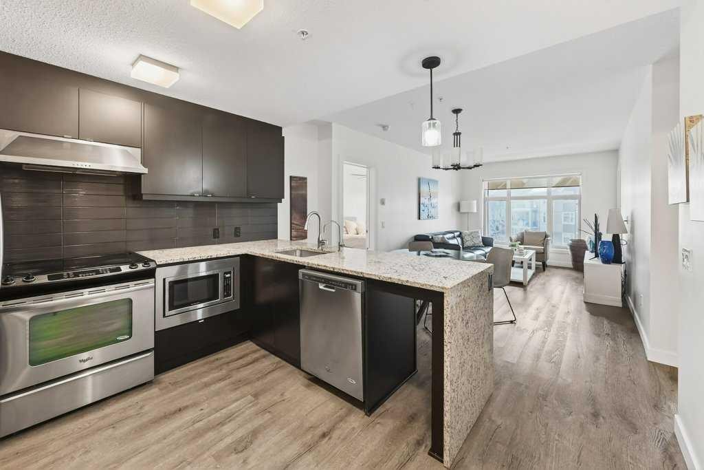 201-25 Aspenmont Heights Sw, Calgary, AB - Indoor Photo Showing Kitchen With Stainless Steel Kitchen With Upgraded Kitchen
