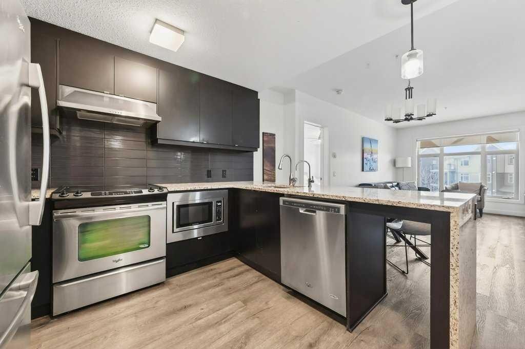 201-25 Aspenmont Heights Sw, Calgary, AB - Indoor Photo Showing Kitchen With Stainless Steel Kitchen With Upgraded Kitchen