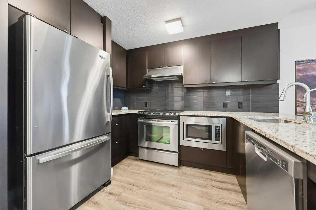 201-25 Aspenmont Heights Sw, Calgary, AB - Indoor Photo Showing Kitchen With Stainless Steel Kitchen With Upgraded Kitchen