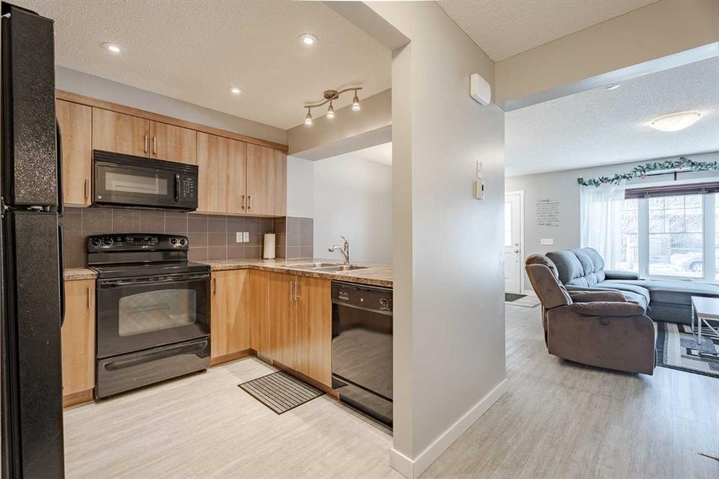 3098 Windsong Boulevard Sw, Airdrie, AB - Indoor Photo Showing Kitchen With Double Sink