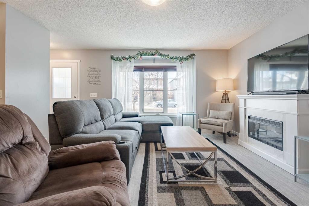 3098 Windsong Boulevard Sw, Airdrie, AB - Indoor Photo Showing Living Room With Fireplace