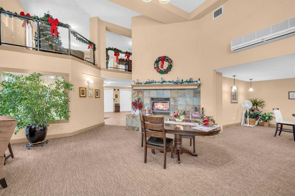 222-428 Chaparral Ravine View Se, Calgary, AB - Indoor Photo Showing Other Room With Fireplace