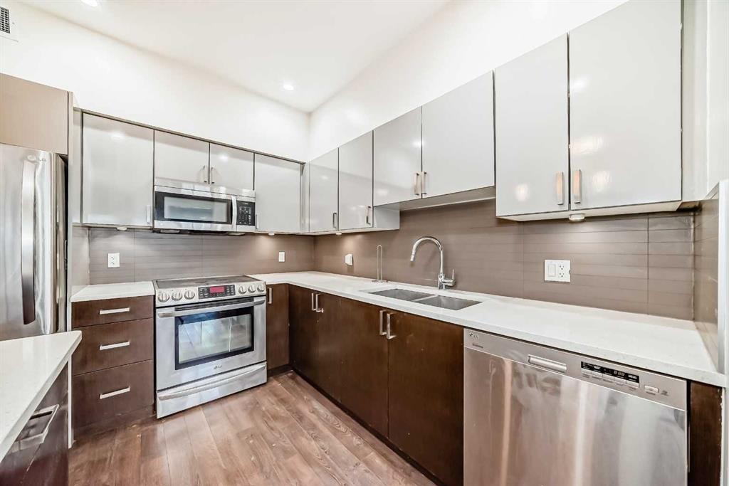 103-10 Auburn Bay Link Se, Calgary, AB - Indoor Photo Showing Kitchen With Stainless Steel Kitchen With Double Sink With Upgraded Kitchen