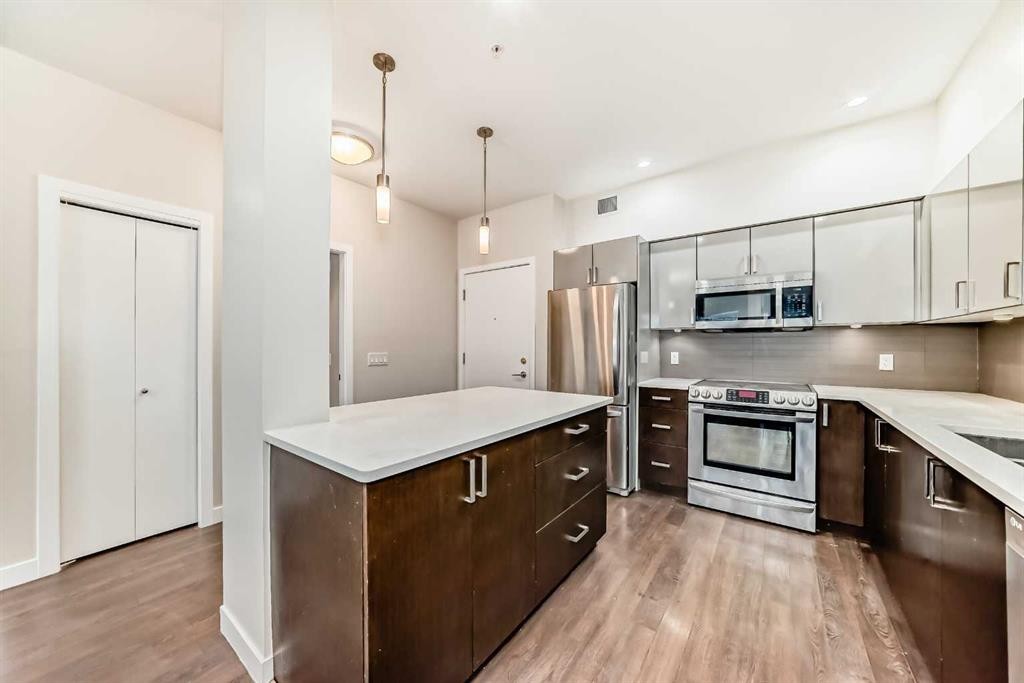 103-10 Auburn Bay Link Se, Calgary, AB - Indoor Photo Showing Kitchen With Stainless Steel Kitchen With Upgraded Kitchen