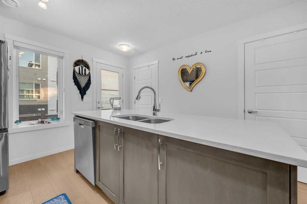 304-474 Seton Circle Se, Calgary, AB - Indoor Photo Showing Kitchen With Double Sink