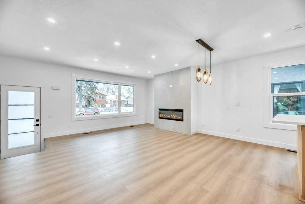 32 Allandale Close Se, Calgary, AB - Indoor Photo Showing Living Room With Fireplace