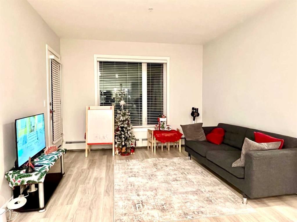 301-150 Shawnee Square Sw, Calgary, AB - Indoor Photo Showing Living Room