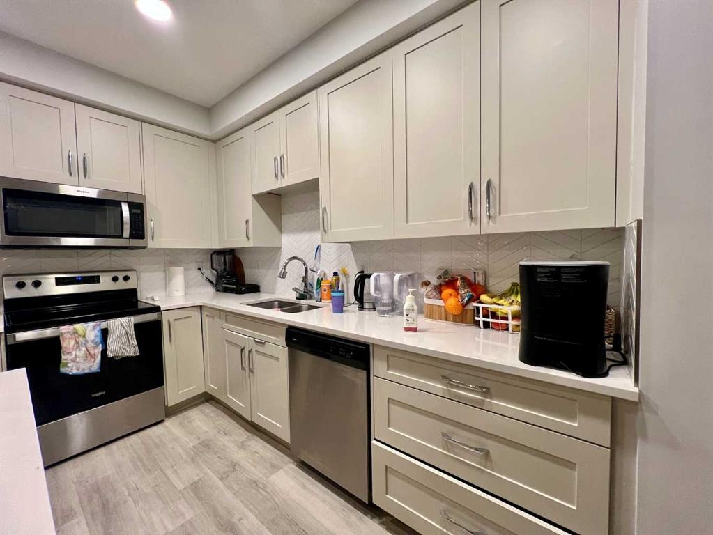 301-150 Shawnee Square Sw, Calgary, AB - Indoor Photo Showing Kitchen With Double Sink