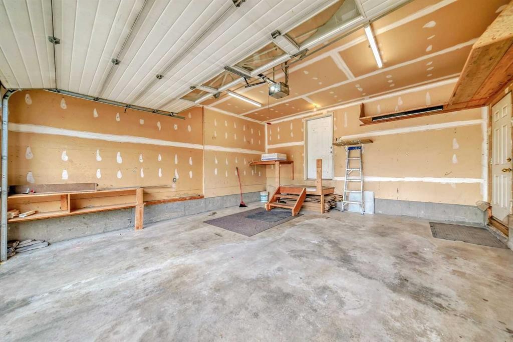 310 Highwood Village Place Nw, High River, AB - Indoor Photo Showing Garage