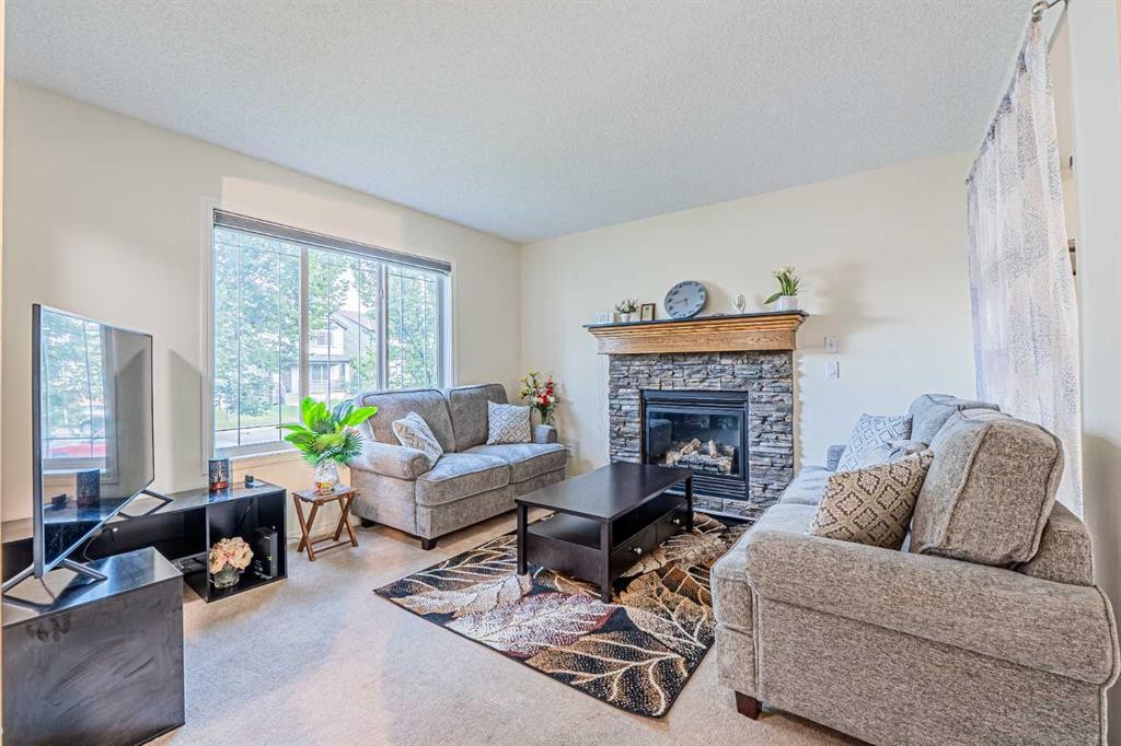 9249 Saddlebrook Drive Ne, Calgary, AB - Indoor Photo Showing Living Room With Fireplace