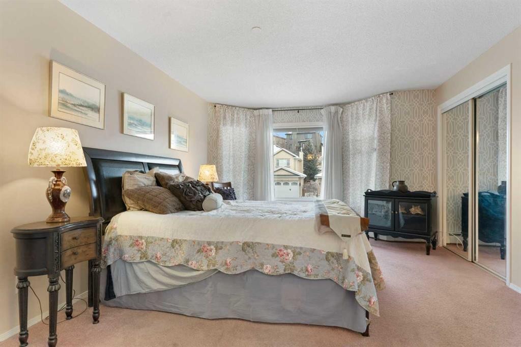 1209-1209 Sienna Park Green Sw, Calgary, AB - Indoor Photo Showing Bedroom With Fireplace