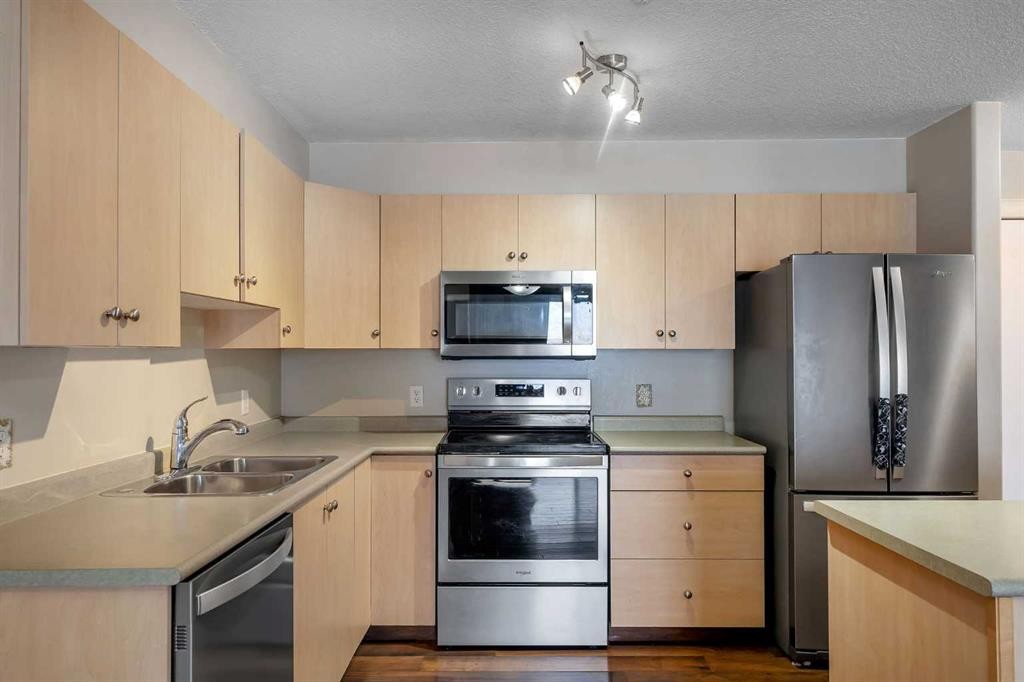 106-5500 Somervale Court Sw, Calgary, AB - Indoor Photo Showing Kitchen With Double Sink