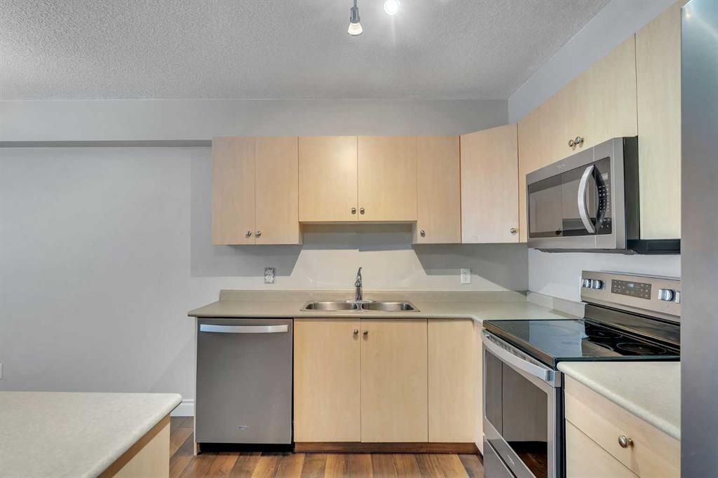 106-5500 Somervale Court Sw, Calgary, AB - Indoor Photo Showing Kitchen With Double Sink