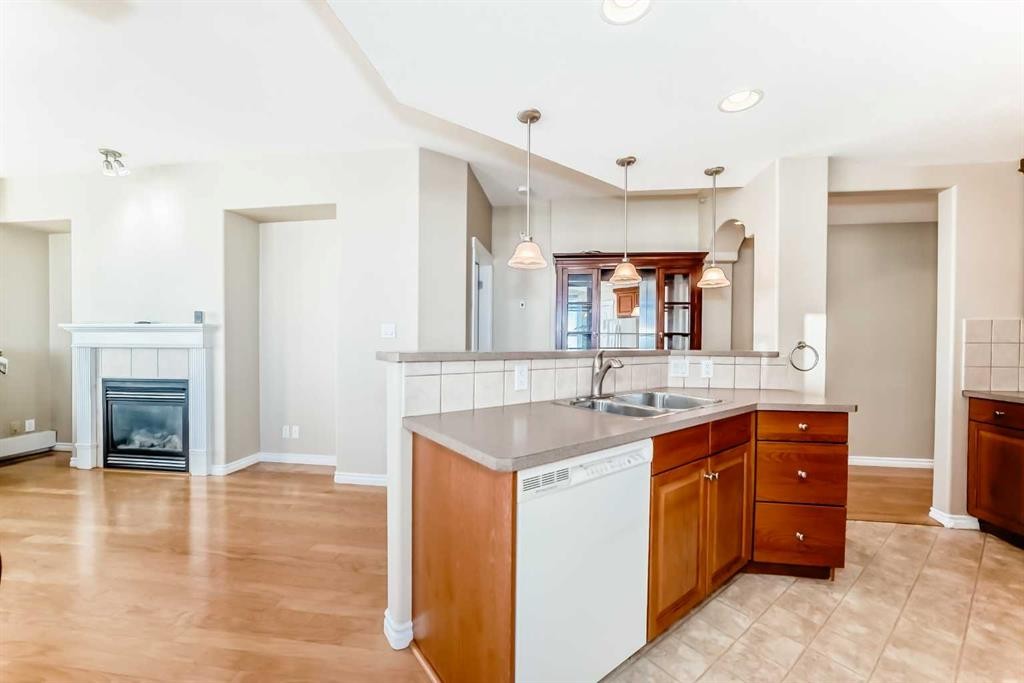 708-1726 14 Avenue Nw, Calgary, AB - Indoor Photo Showing Kitchen With Fireplace With Double Sink