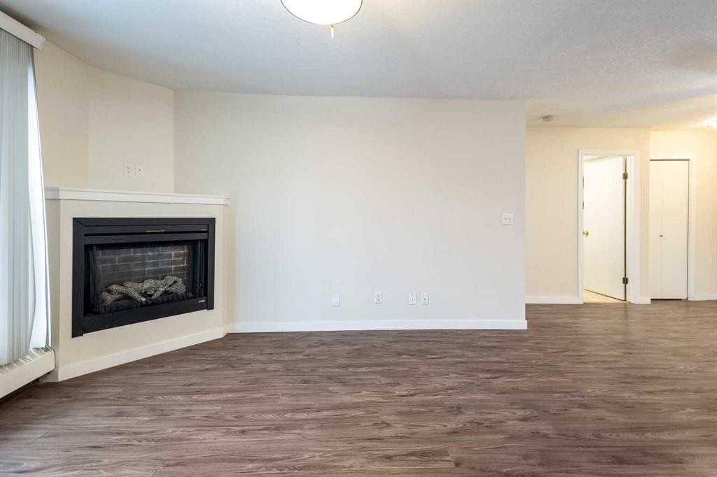 101-3747 42 Street Nw, Calgary, AB - Indoor Photo Showing Living Room With Fireplace