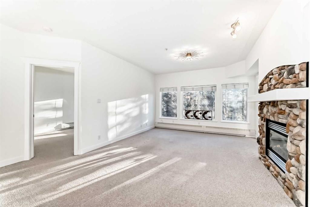 213-10 Discovery Ridge Close Sw, Calgary, AB - Indoor Photo Showing Other Room With Fireplace