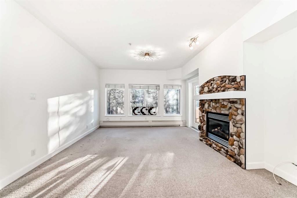 213-10 Discovery Ridge Close Sw, Calgary, AB - Indoor Photo Showing Other Room With Fireplace