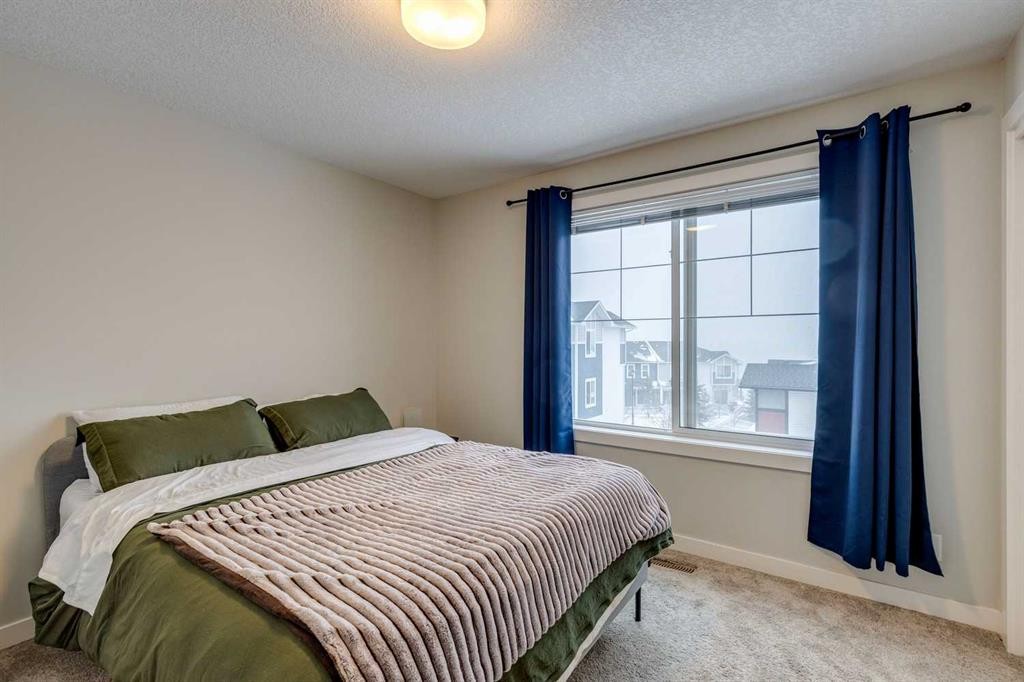 2103 Jumping Pound Common, Cochrane, AB - Indoor Photo Showing Bedroom