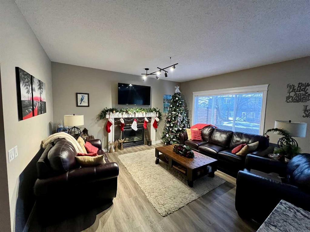 2117 Reunion Boulevard Nw, Airdrie, AB - Indoor Photo Showing Living Room With Fireplace