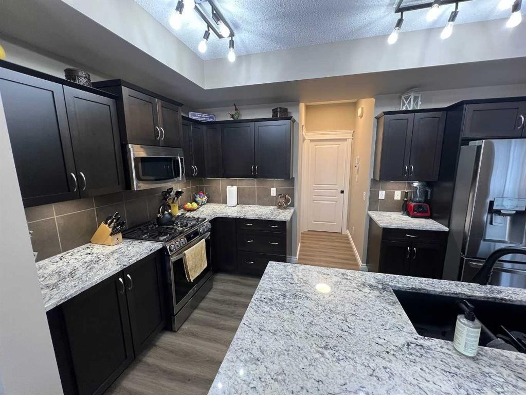 2117 Reunion Boulevard Nw, Airdrie, AB - Indoor Photo Showing Kitchen With Stainless Steel Kitchen With Upgraded Kitchen