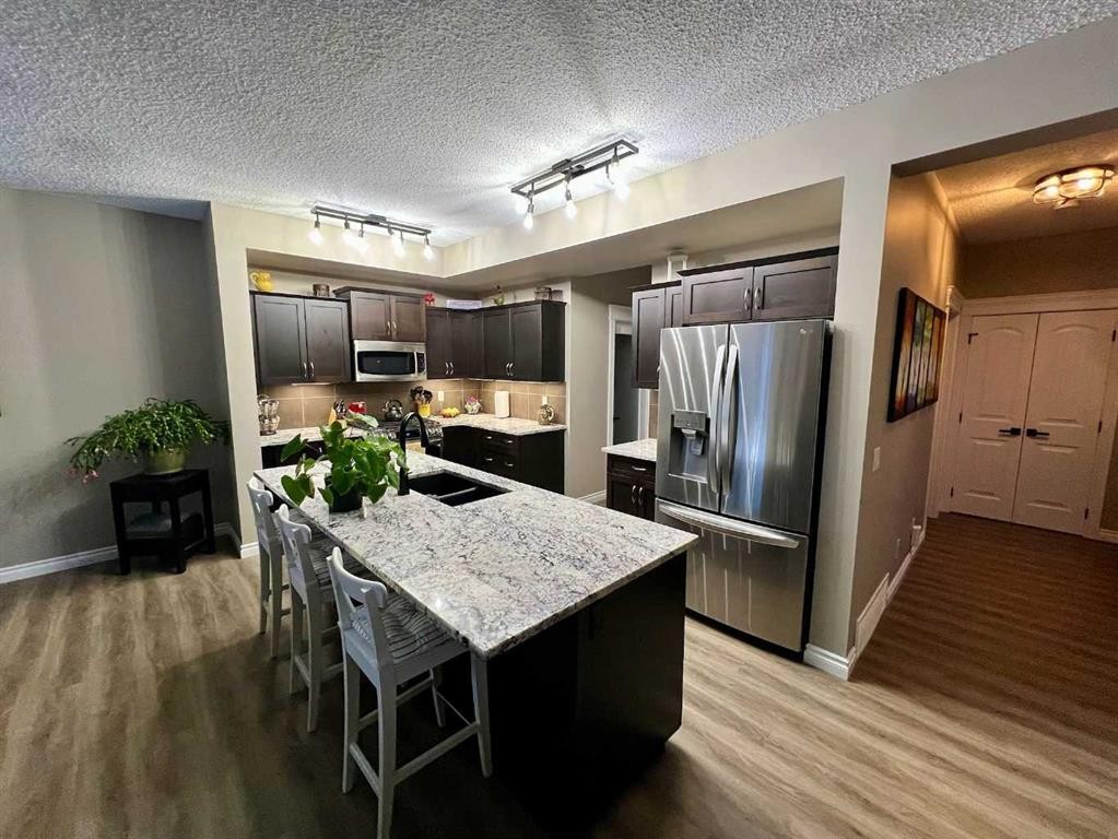 2117 Reunion Boulevard Nw, Airdrie, AB - Indoor Photo Showing Kitchen With Stainless Steel Kitchen With Double Sink With Upgraded Kitchen