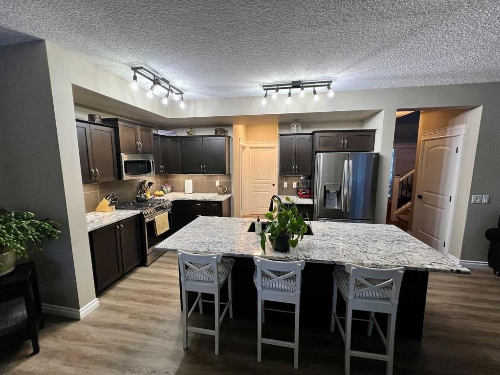 2117 Reunion Boulevard Nw, Airdrie, AB - Indoor Photo Showing Kitchen With Stainless Steel Kitchen With Upgraded Kitchen