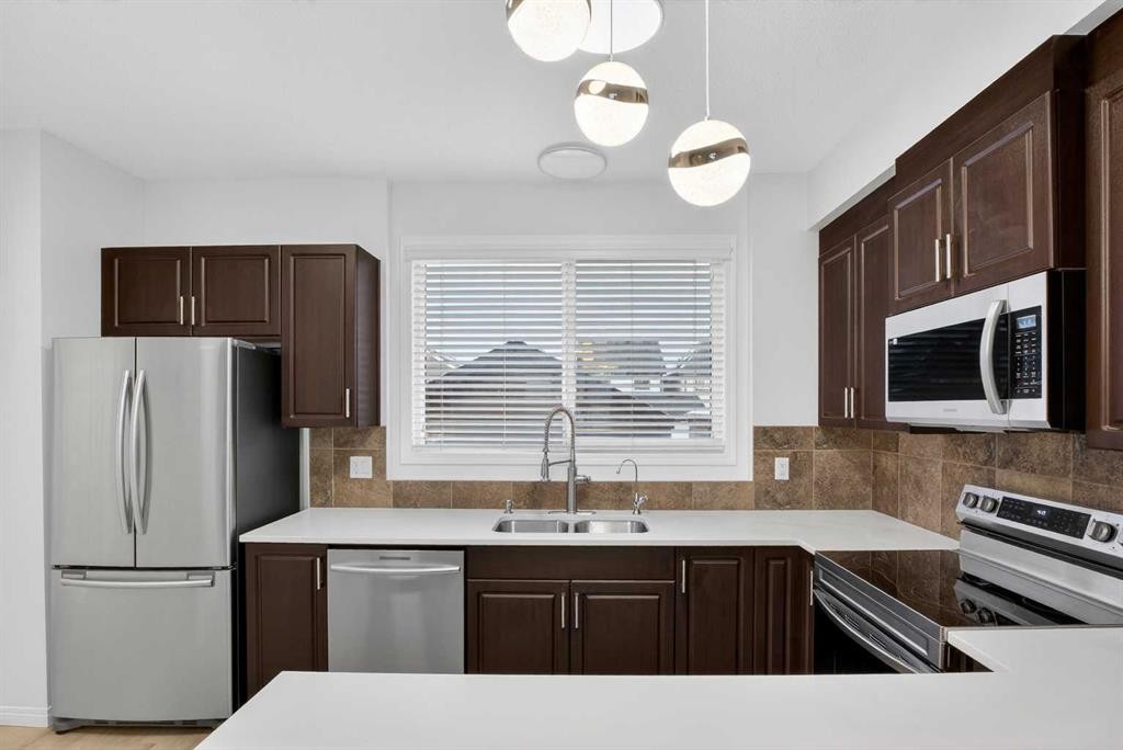104 Masters Link Se, Calgary, AB - Indoor Photo Showing Kitchen With Stainless Steel Kitchen With Double Sink