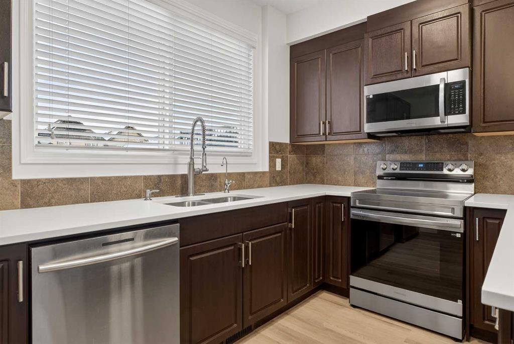 104 Masters Link Se, Calgary, AB - Indoor Photo Showing Kitchen With Double Sink