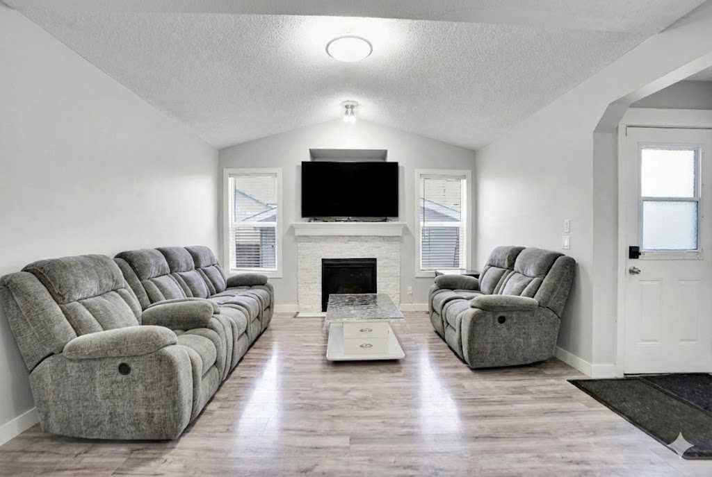 9214 Saddlebrook Drive Ne, Calgary, AB - Indoor Photo Showing Living Room With Fireplace