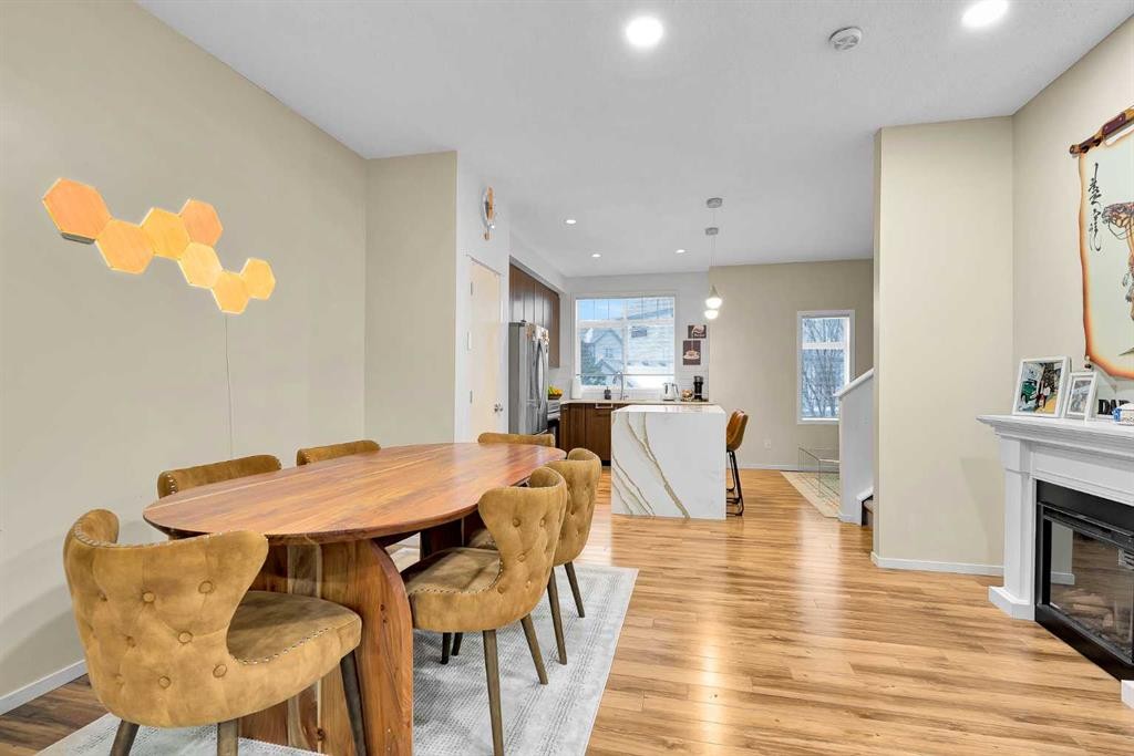 300 Copperstone Cove Se, Calgary, AB - Indoor Photo Showing Dining Room With Fireplace