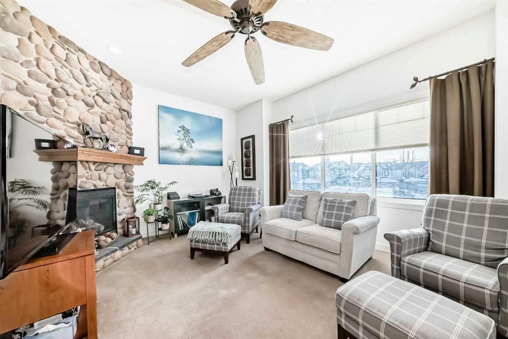 198 Brightonstone Bay Se, Calgary, AB - Indoor Photo Showing Living Room With Fireplace