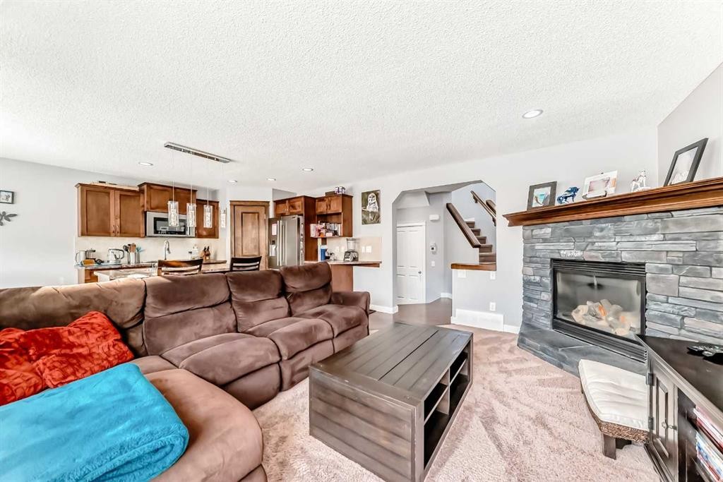 562 New Brighton Drive Se, Calgary, AB - Indoor Photo Showing Living Room With Fireplace