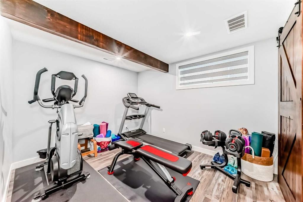 562 New Brighton Drive Se, Calgary, AB - Indoor Photo Showing Gym Room
