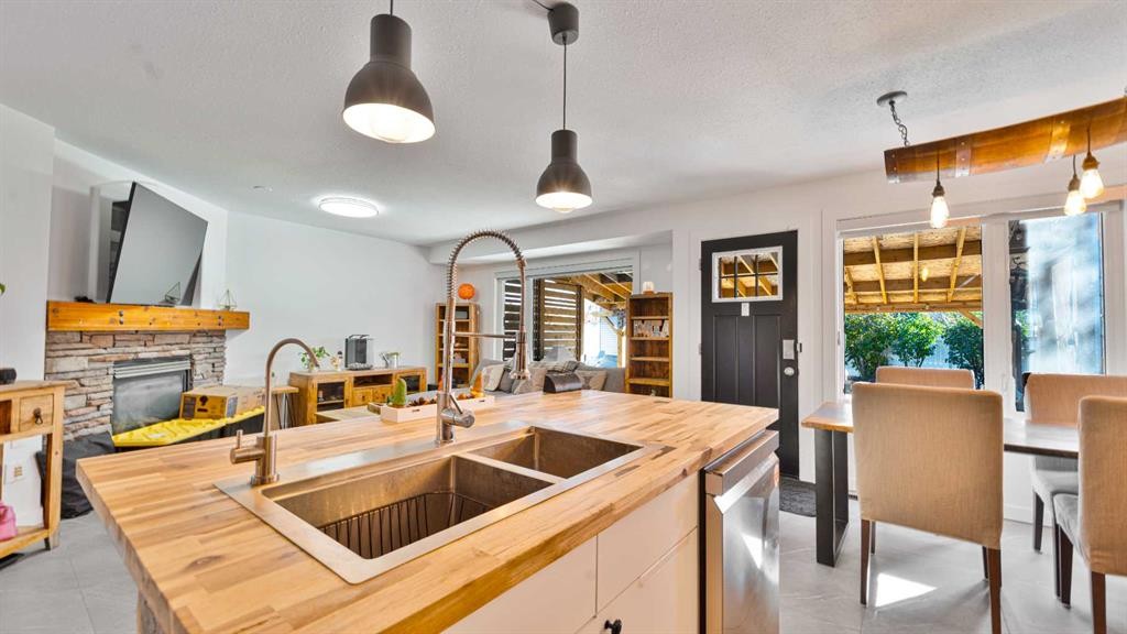 148 Covepark Close Ne, Calgary, AB - Indoor Photo Showing Kitchen With Fireplace With Double Sink
