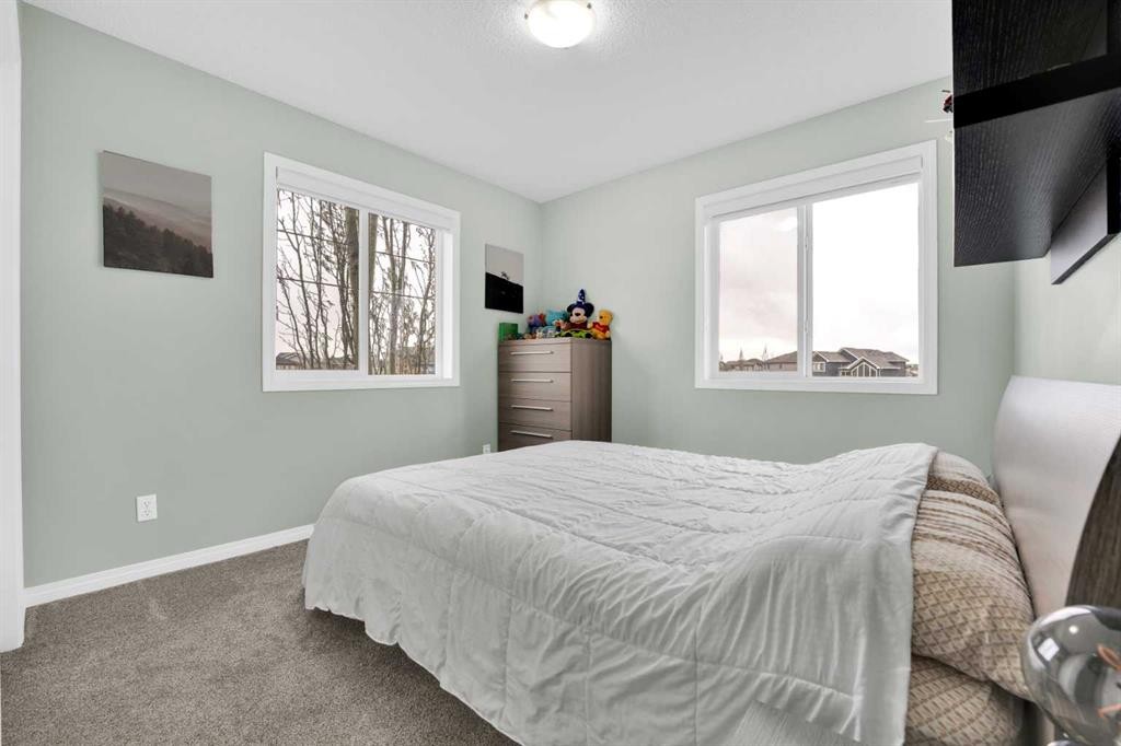2101 Luxstone Boulevard Sw, Airdrie, AB - Indoor Photo Showing Bedroom