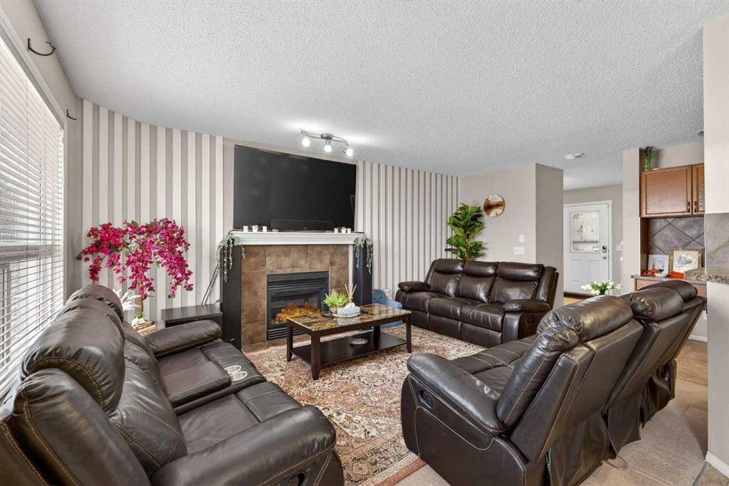 106 Saddlecrest Crescent Ne, Calgary, AB - Indoor Photo Showing Living Room With Fireplace