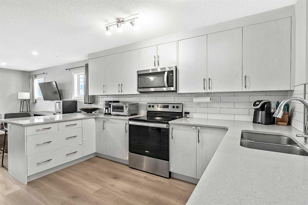 130 Cranbrook Square Se, Calgary, AB - Indoor Photo Showing Kitchen With Double Sink