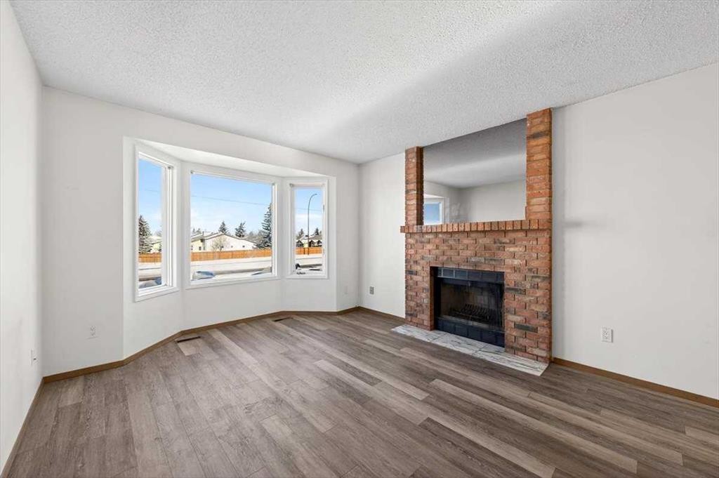 184 Falmere Way Ne, Calgary, AB - Indoor Photo Showing Living Room With Fireplace