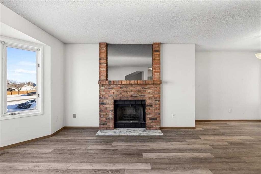 184 Falmere Way Ne, Calgary, AB - Indoor Photo Showing Living Room With Fireplace
