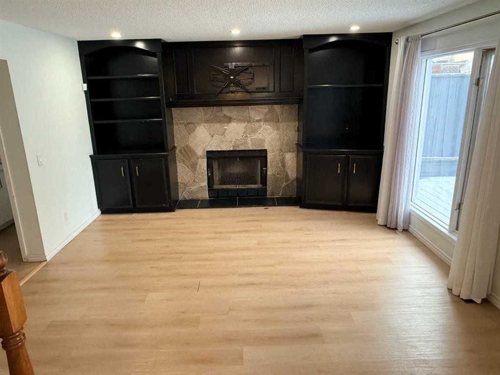 651 Macewan Drive Nw, Calgary, AB - Indoor Photo Showing Other Room With Fireplace