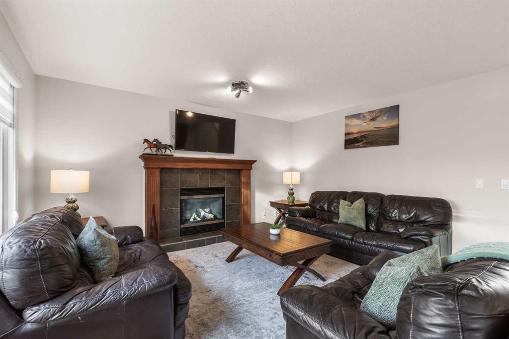 7 Everglade Circle Sw, Calgary, AB - Indoor Photo Showing Living Room With Fireplace