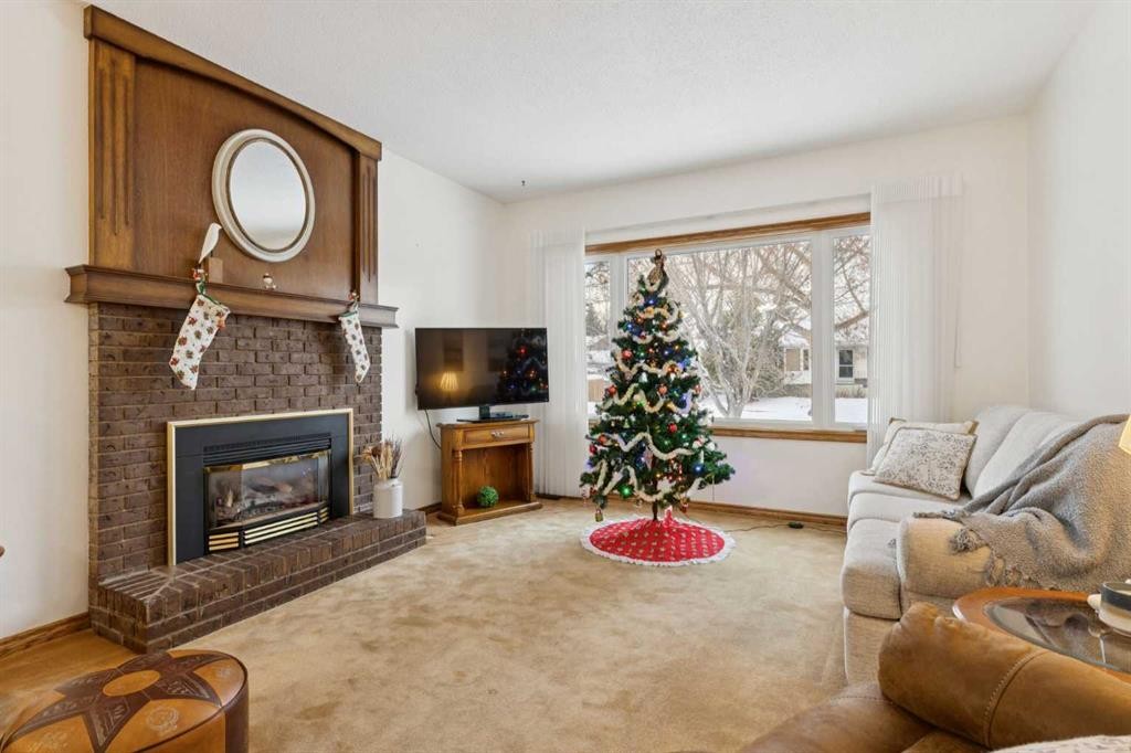3221 Cedarille Drive Sw, Calgary, AB - Indoor Photo Showing Living Room With Fireplace
