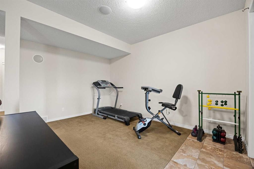 43 Ranchers Crescent, Okotoks, AB - Indoor Photo Showing Gym Room